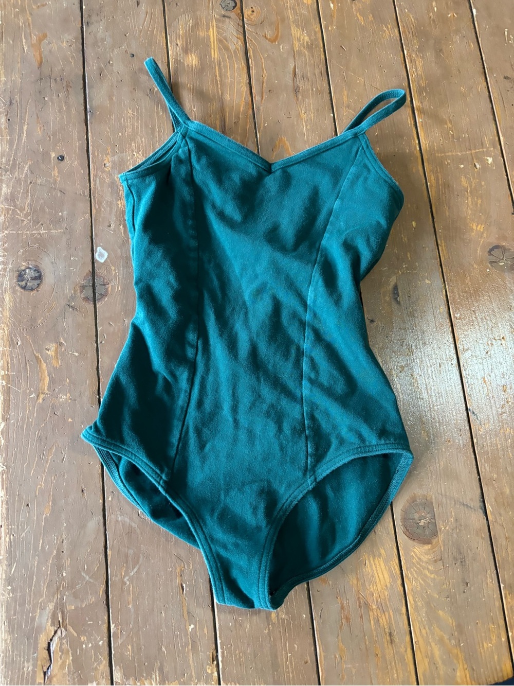 Capezio forest green camisole leotard with a v-neckline and princess seams.